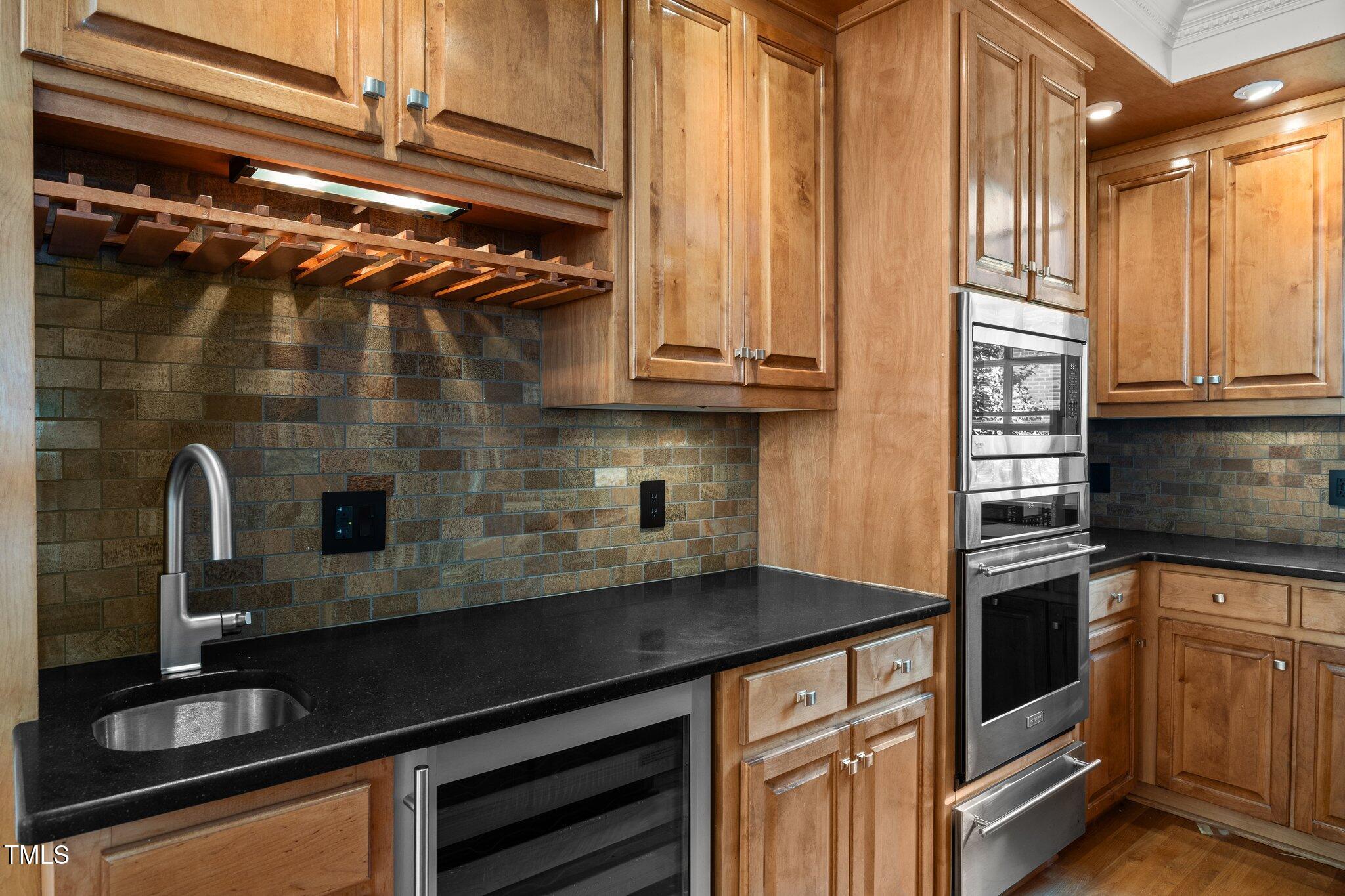 3604 Eden Croft Drive Raleigh, NC 27612 - Photo 18 of 49 a kitchen with a sink and cabinets
