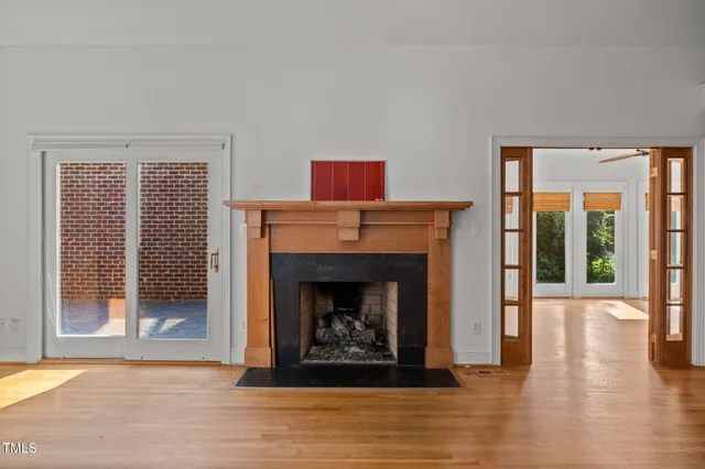 a living room with a fireplace and a floor to ceiling window