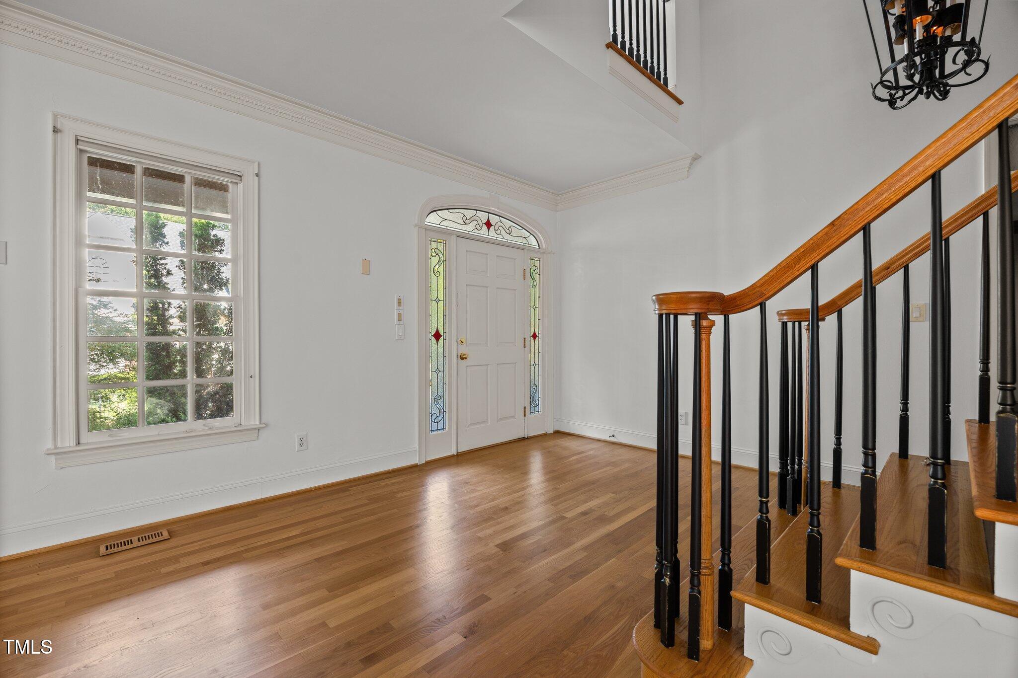 3604 Eden Croft Drive Raleigh, NC 27612 - Photo 2 of 49 a view of an empty room with wooden floor and a window