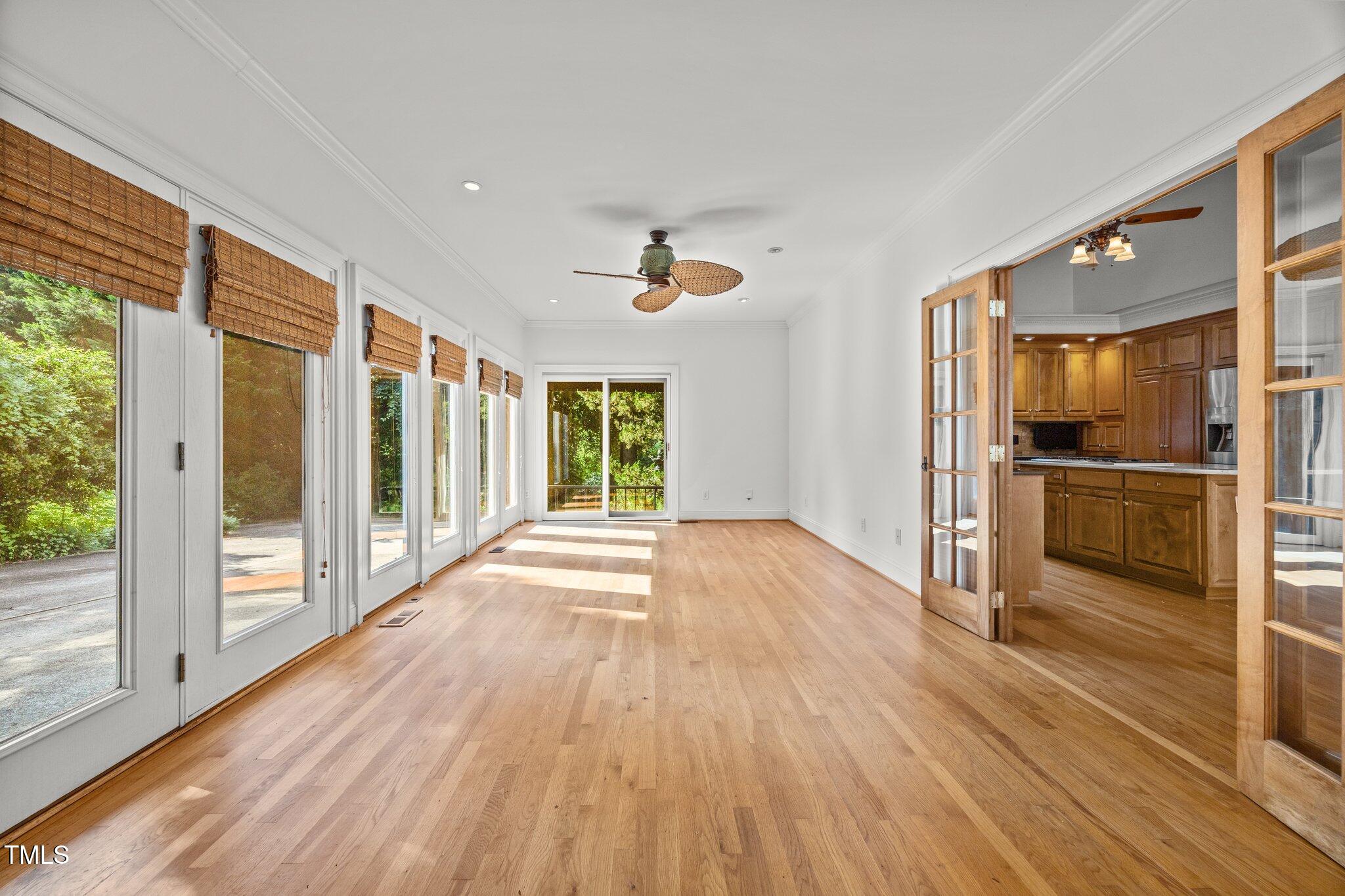 3604 Eden Croft Drive Raleigh, NC 27612 - Photo 25 of 49 a view of a kitchen with wooden floor a ceiling fan and windows