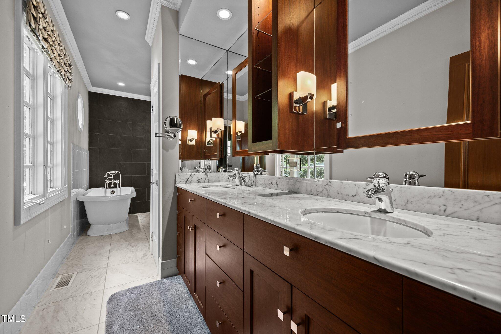 3604 Eden Croft Drive Raleigh, NC 27612 - Photo 31 of 49 a bathroom with a double vanity sink and a mirror