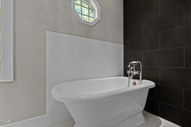 a white bath tub sitting in a bathroom