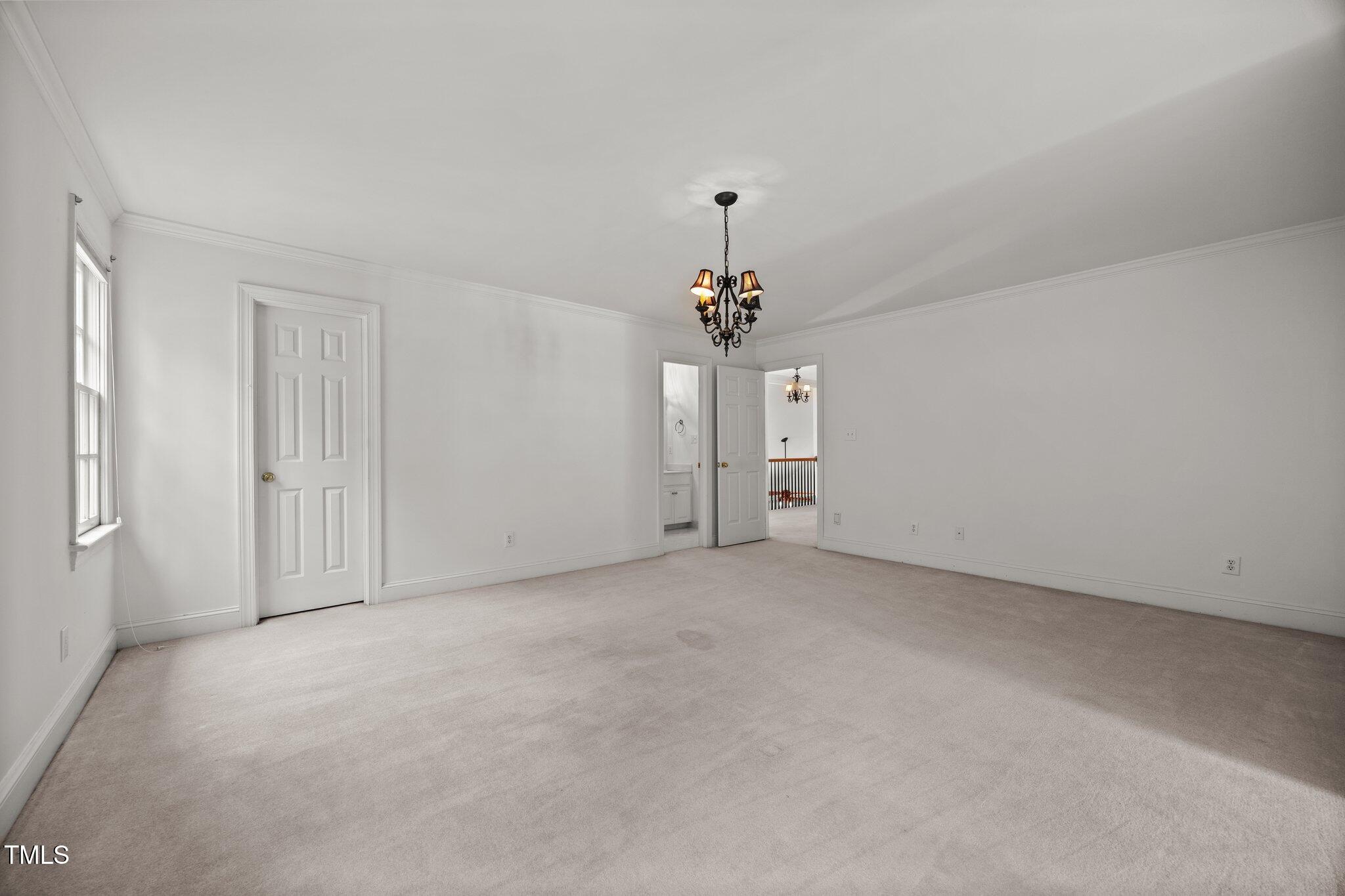 3604 Eden Croft Drive Raleigh, NC 27612 - Photo 35 of 49 a view of empty room with a chandelier fan