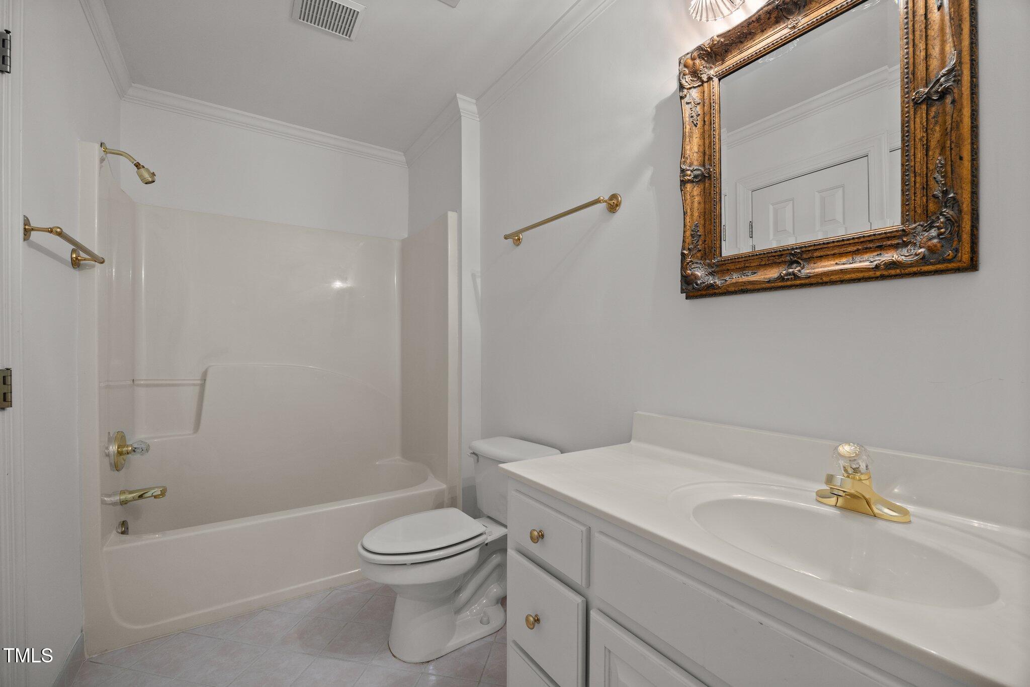 3604 Eden Croft Drive Raleigh, NC 27612 - Photo 36 of 49 a bathroom with a toilet a sink and a bathtub