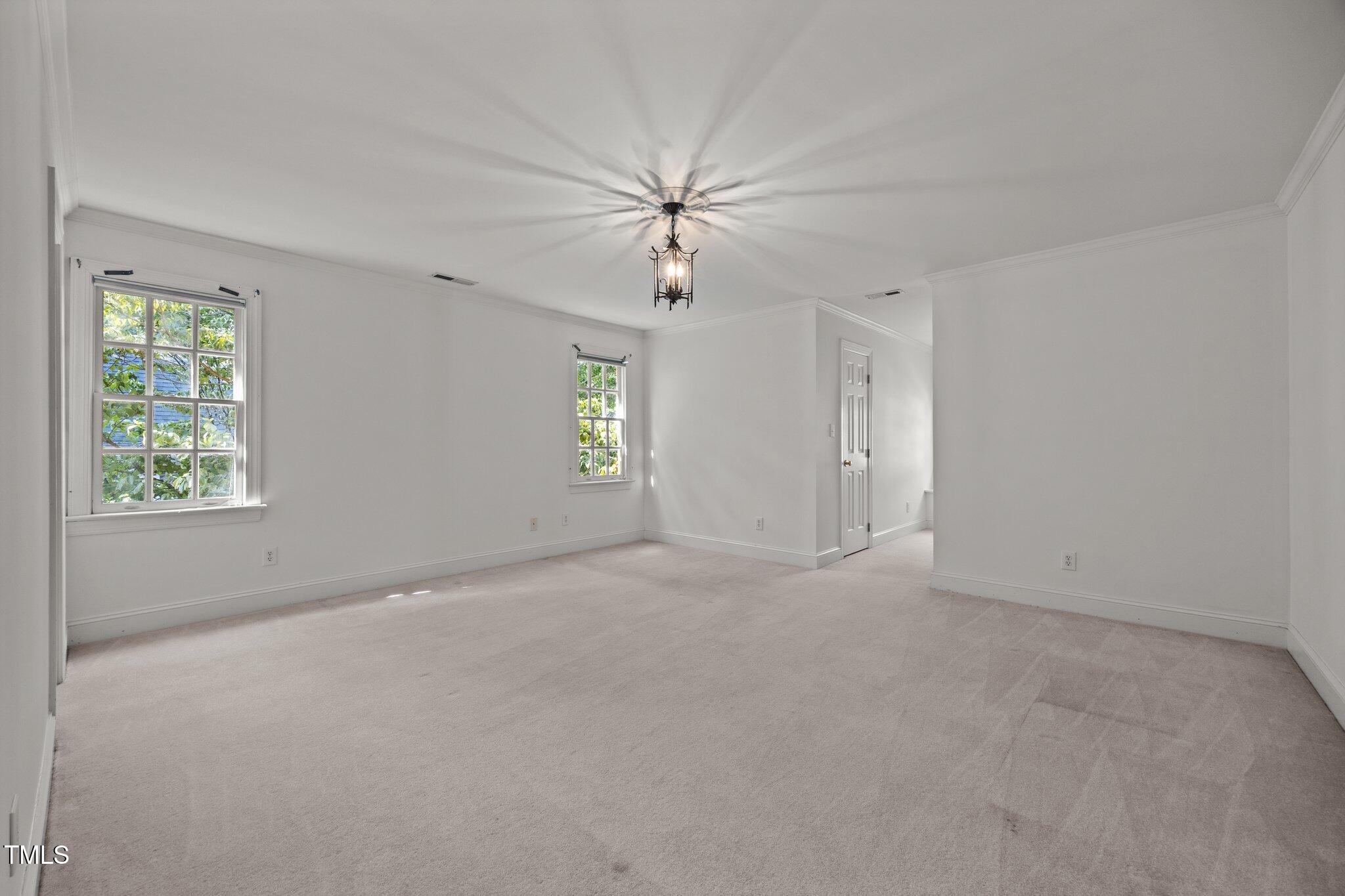 3604 Eden Croft Drive Raleigh, NC 27612 - Photo 38 of 49 an empty room with windows and fan