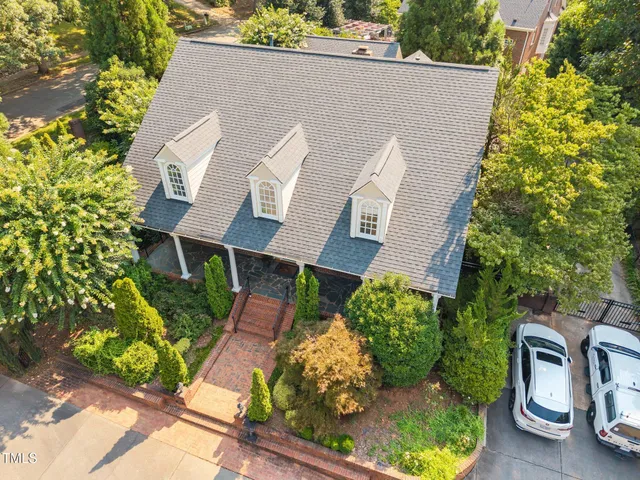 a aerial view of a house with a yard and potted plants