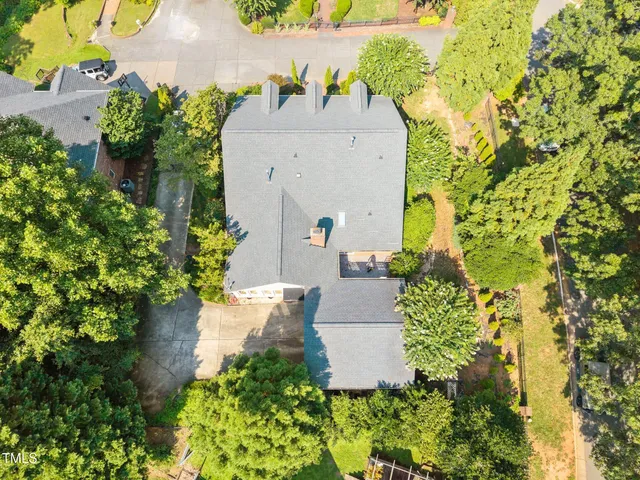 an aerial view of a house with a yard
