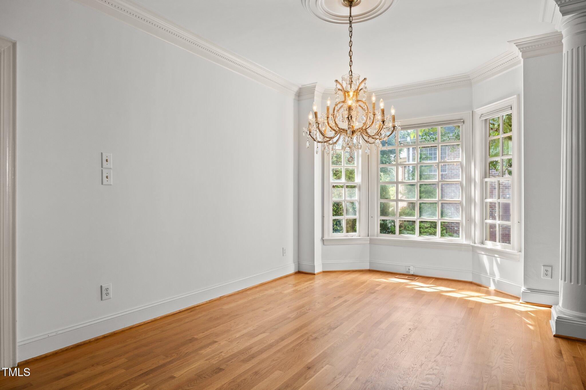 3604 Eden Croft Drive Raleigh, NC 27612 - Photo 7 of 49 a view of an empty room with a window and wooden floor