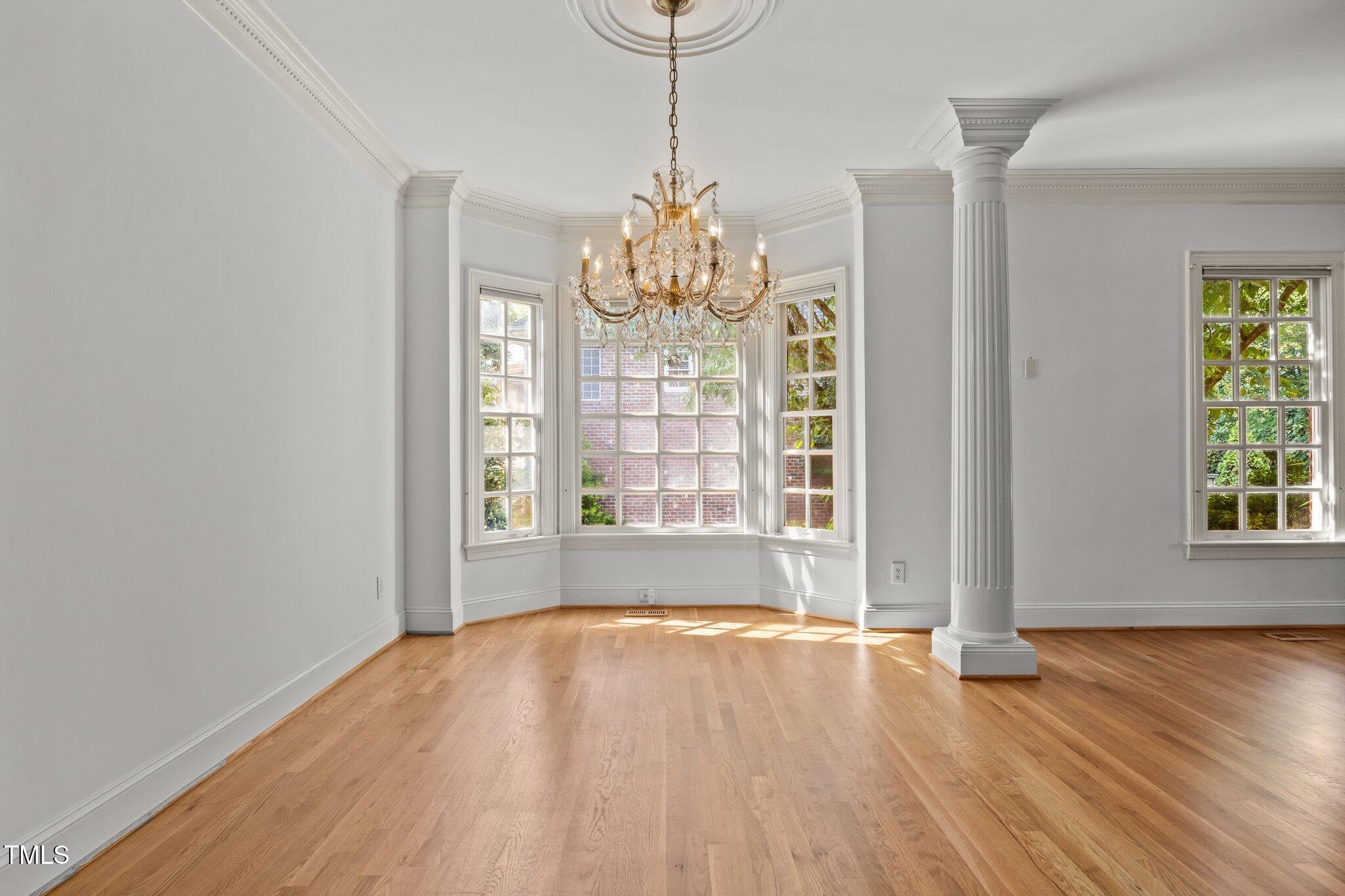 3604 Eden Croft Drive Raleigh, NC 27612 - Photo 8 of 49 a view of an empty room with wooden floor and a window