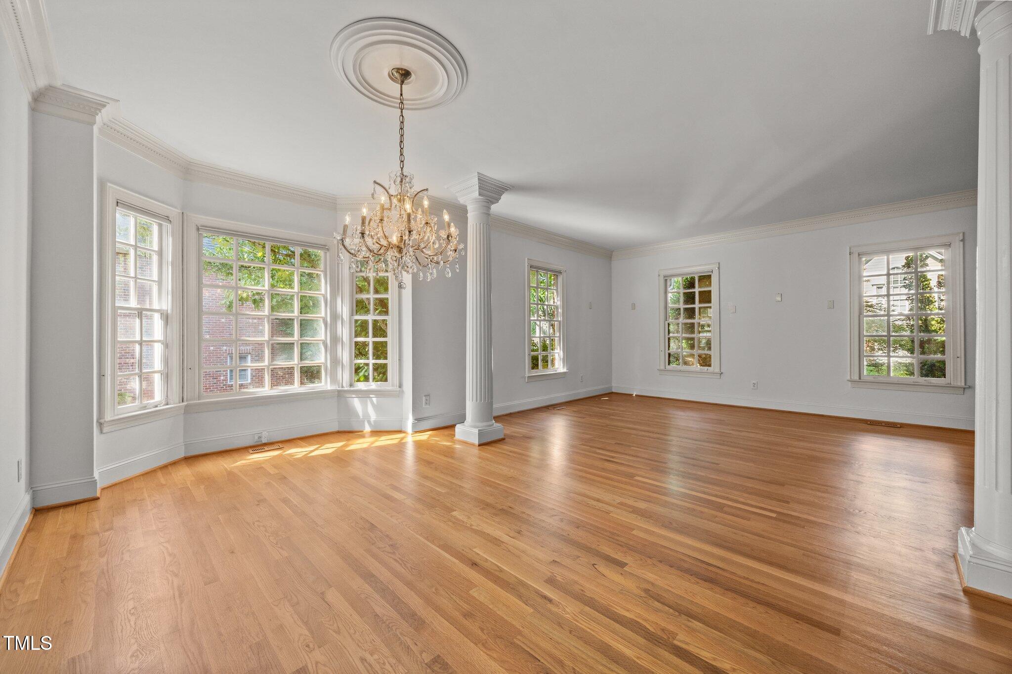 3604 Eden Croft Drive Raleigh, NC 27612 - Photo 9 of 49 a view of an empty room with window and wooden floor