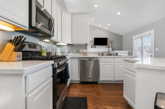 13176 Day Court Draper, UT 84020 - Photo 11 of 45 Kitchen featuring stainless steel appliances, lofted ceiling, white cabinets, light stone counters, and dark wood-type flooring