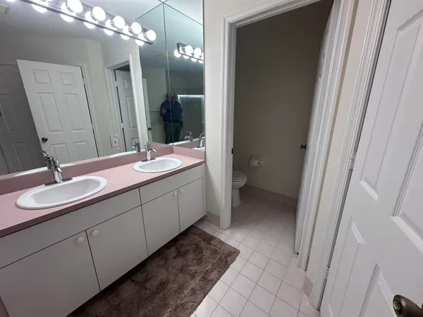a bathroom with a double vanity sink and a mirror