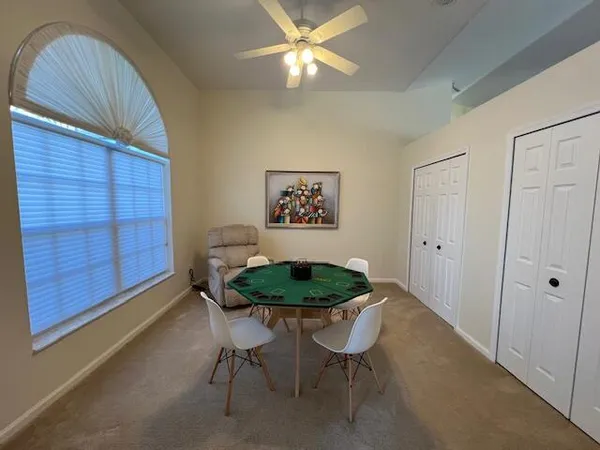 a dining room with furniture and a lamp