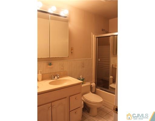 36 Huntington Road Edison, NJ 08820 - Photo 11 of 19 a bathroom with a sink a toilet and shower