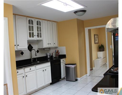 36 Huntington Road Edison, NJ 08820 - Photo 3 of 19 a kitchen with a sink and cabinets