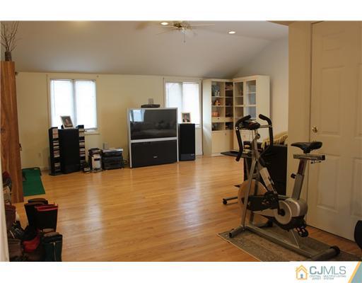 36 Huntington Road Edison, NJ 08820 - Photo 6 of 19 a living room with furniture a flat screen tv and a refrigerator