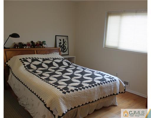 36 Huntington Road Edison, NJ 08820 - Photo 10 of 19 a bedroom with a bed and dresser