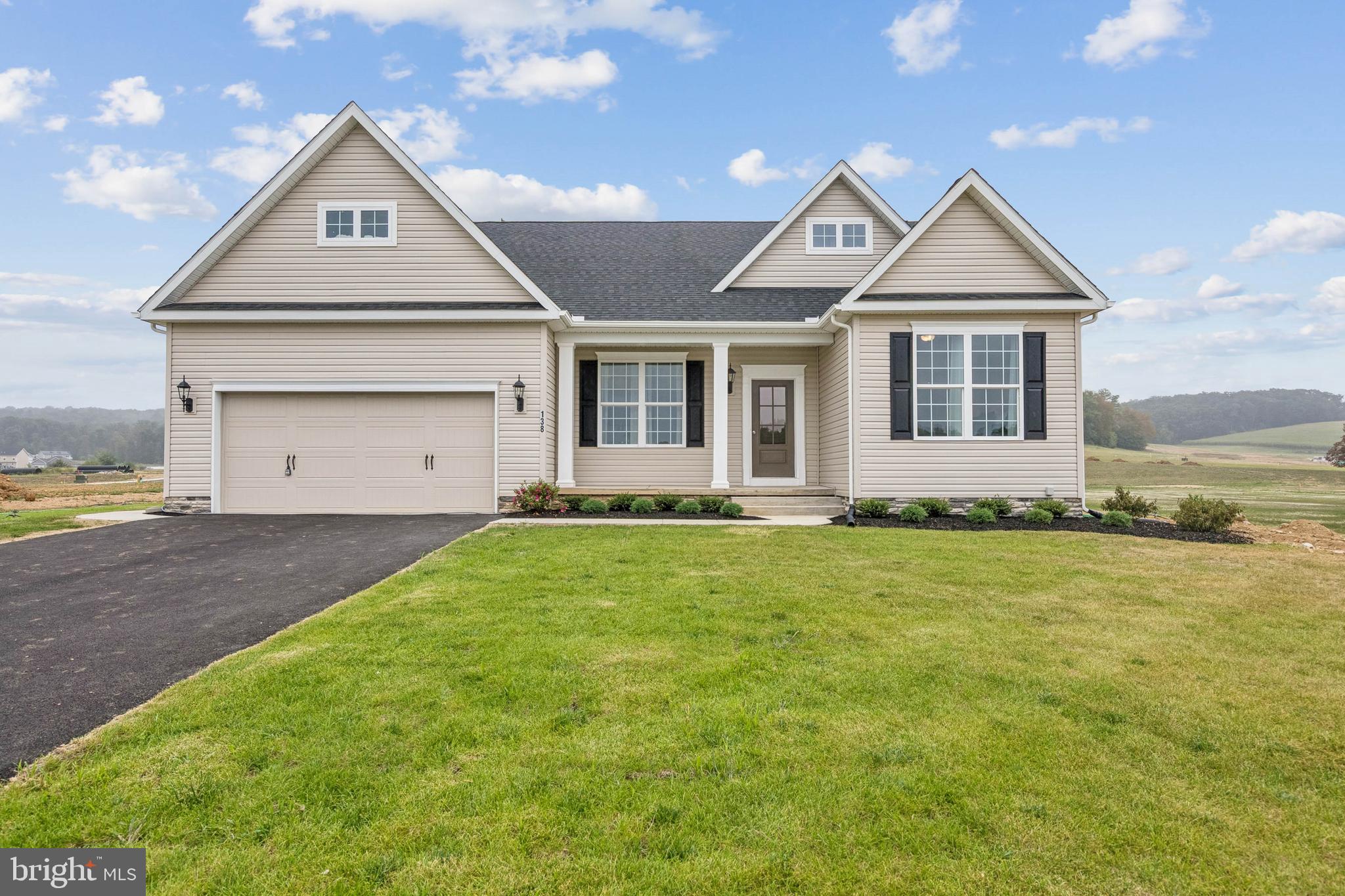 150 Piedmont Way, Unit 101 Hanover, PA 17331 - Photo 1 of 40 a front view of a house with a yard and garage