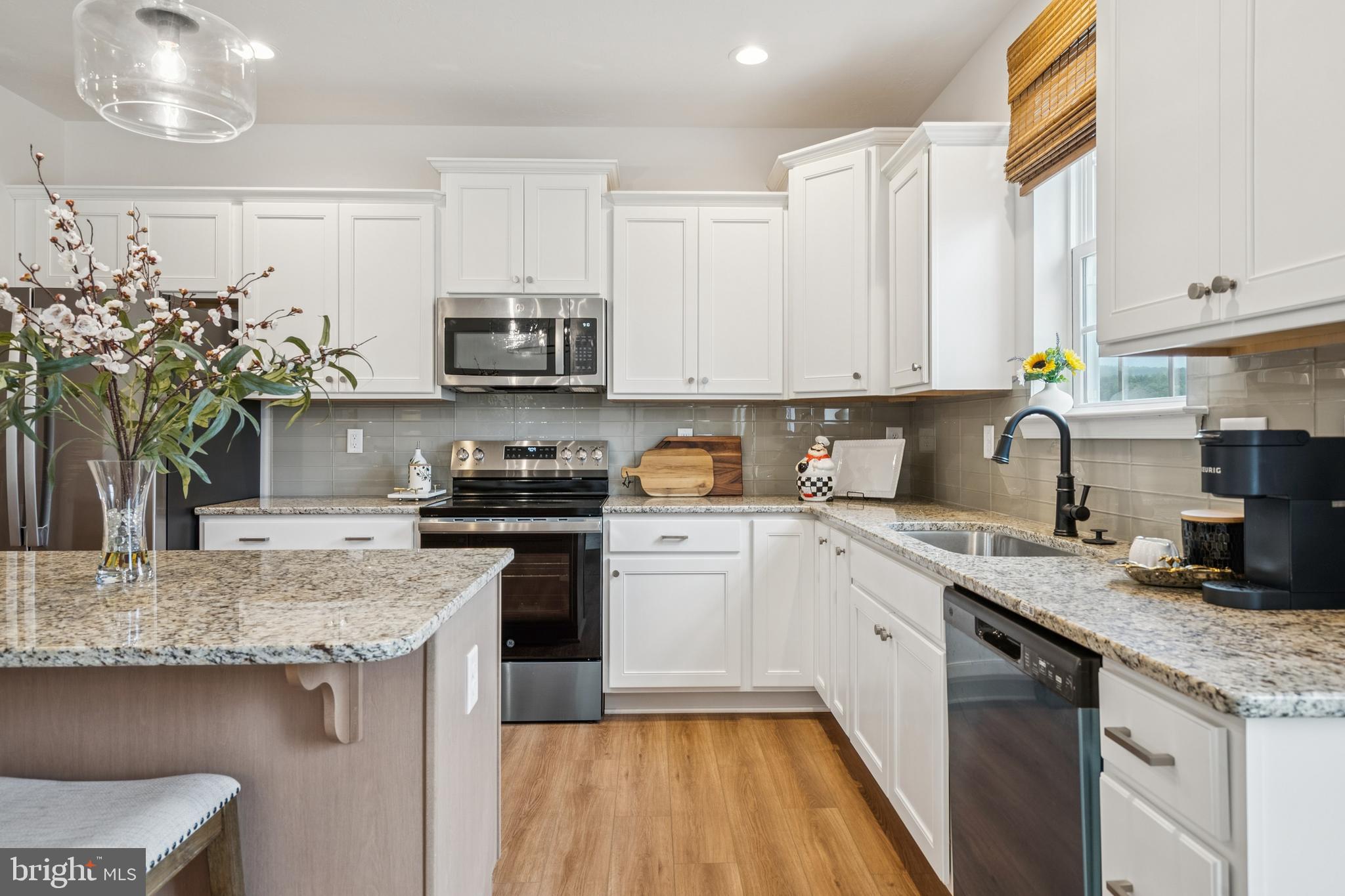 150 Piedmont Way, Unit 101 Hanover, PA 17331 - Photo 12 of 40 a kitchen with a sink stove and cabinets