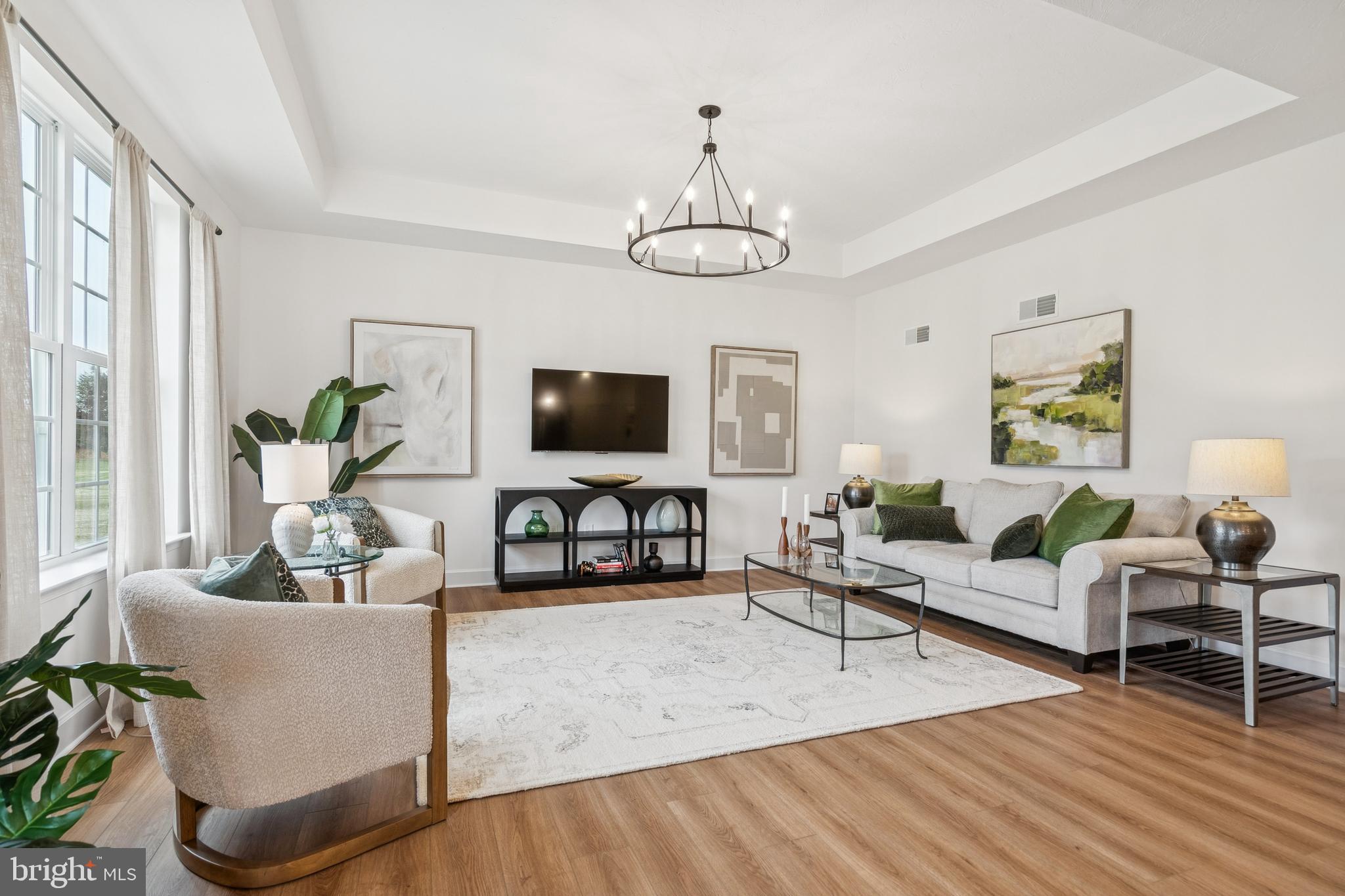 150 Piedmont Way, Unit 101 Hanover, PA 17331 - Photo 19 of 40 a living room with furniture chandelier and a flat screen tv