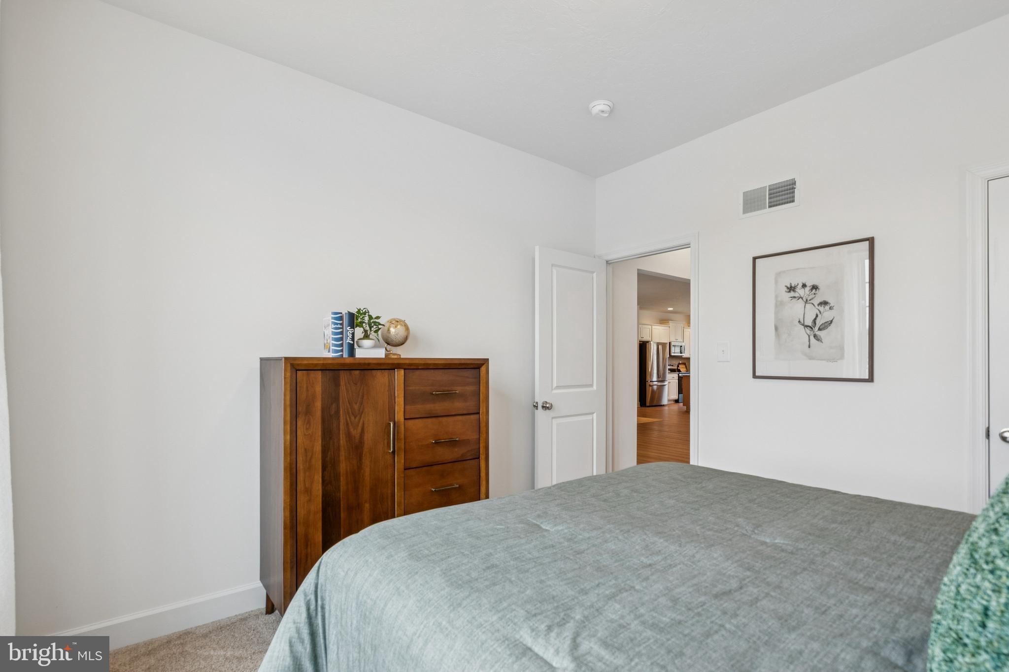 150 Piedmont Way, Unit 101 Hanover, PA 17331 - Photo 34 of 40 a bedroom with a bed and a dresser