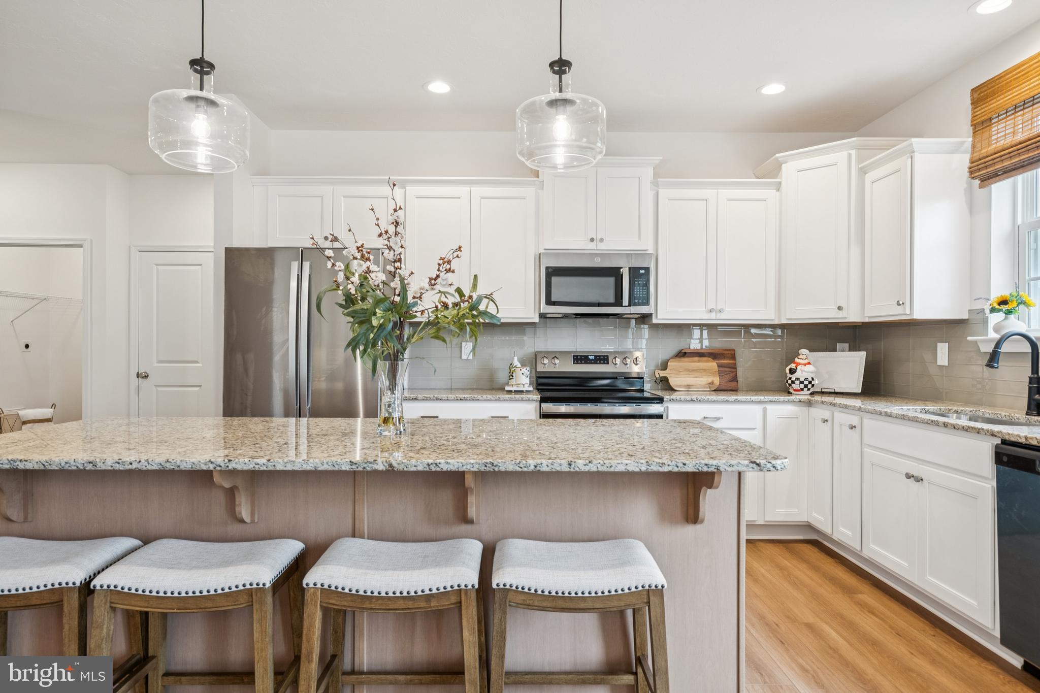 150 Piedmont Way, Unit 101 Hanover, PA 17331 - Photo 10 of 40 a kitchen with stainless steel appliances granite countertop a sink a stove a refrigerator cabinets and chairs