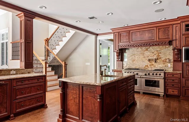 a kitchen with stainless steel appliances granite countertop a stove and a sink