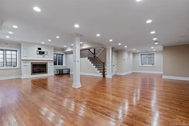 a view of a livingroom with a fireplace a staircase and a kitchen