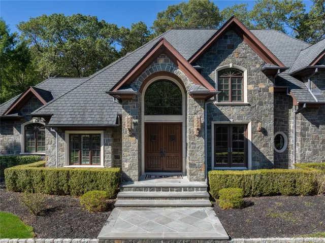 a front view of a house with a garden