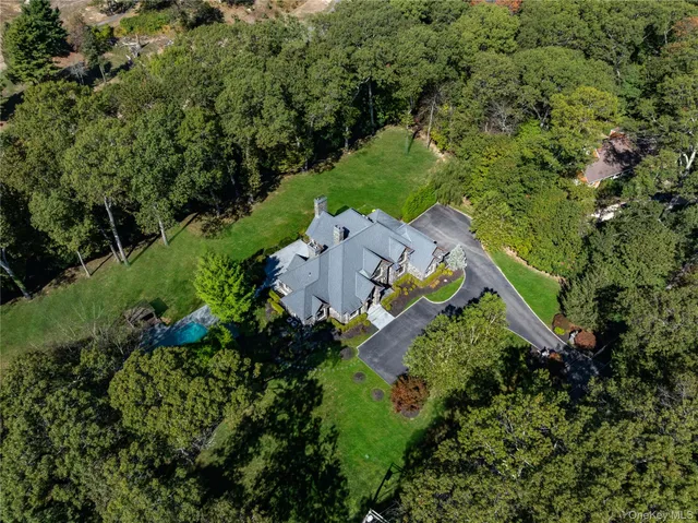 an aerial view of a house with a yard