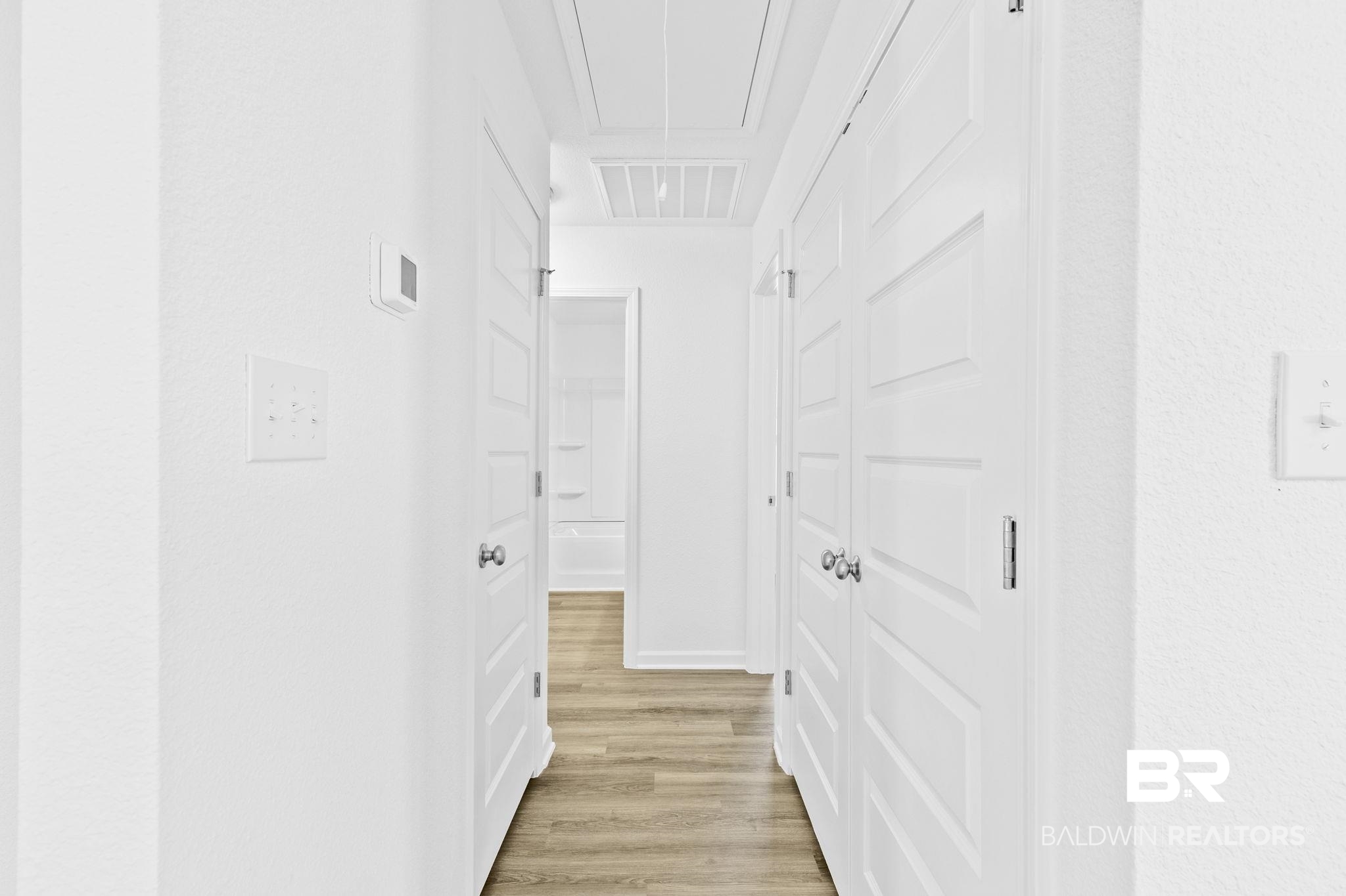 16014 Alabama Avenue Silverhill, AL 36576 - Photo 27 of 50 Hallway with light hardwood / wood-style flooring
