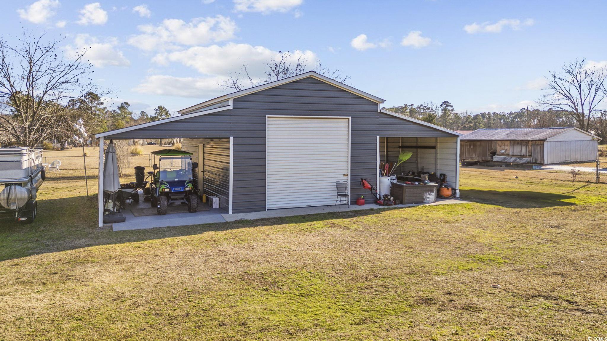 1109 Dunn Short Cut Road Conway, SC 29527 - Photo 30 of 37 Garage featuring a lawn