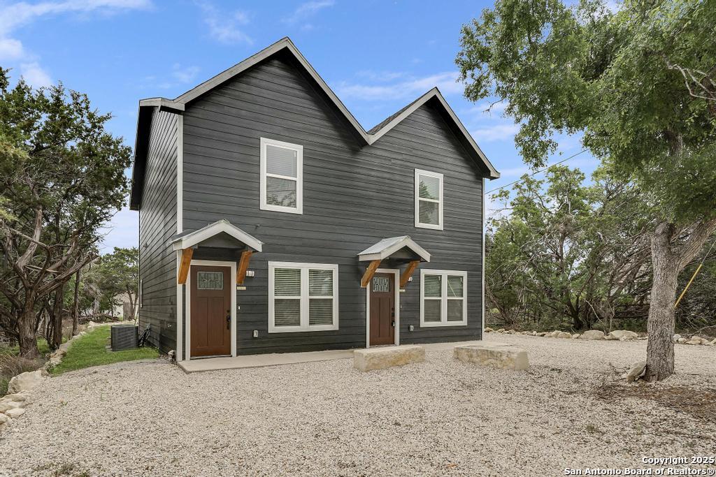 349 Will Rogers Drive, Unit B Spring Branch, TX 78070 - Photo 1 of 15 a front view of a house with a yard and garage