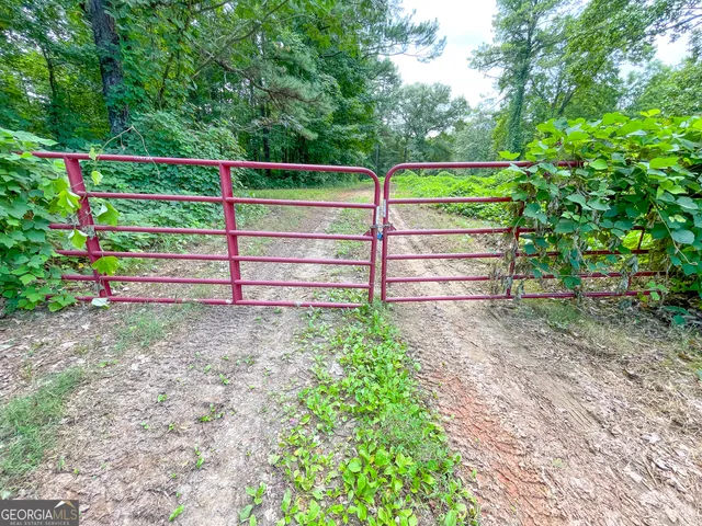a view of a wooden fence of a house with a yard