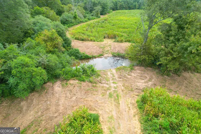 a view of a large body of water with a house in the background