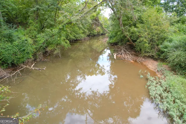 a view of a street with a bench next to a road
