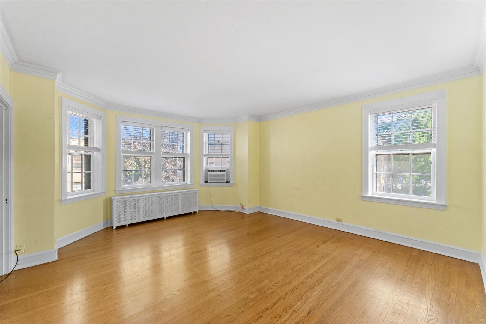 1316 Maple Avenue, Unit E3 Evanston, IL 60201 - Photo 3 of 22 a view of an empty room with a window and wooden floor