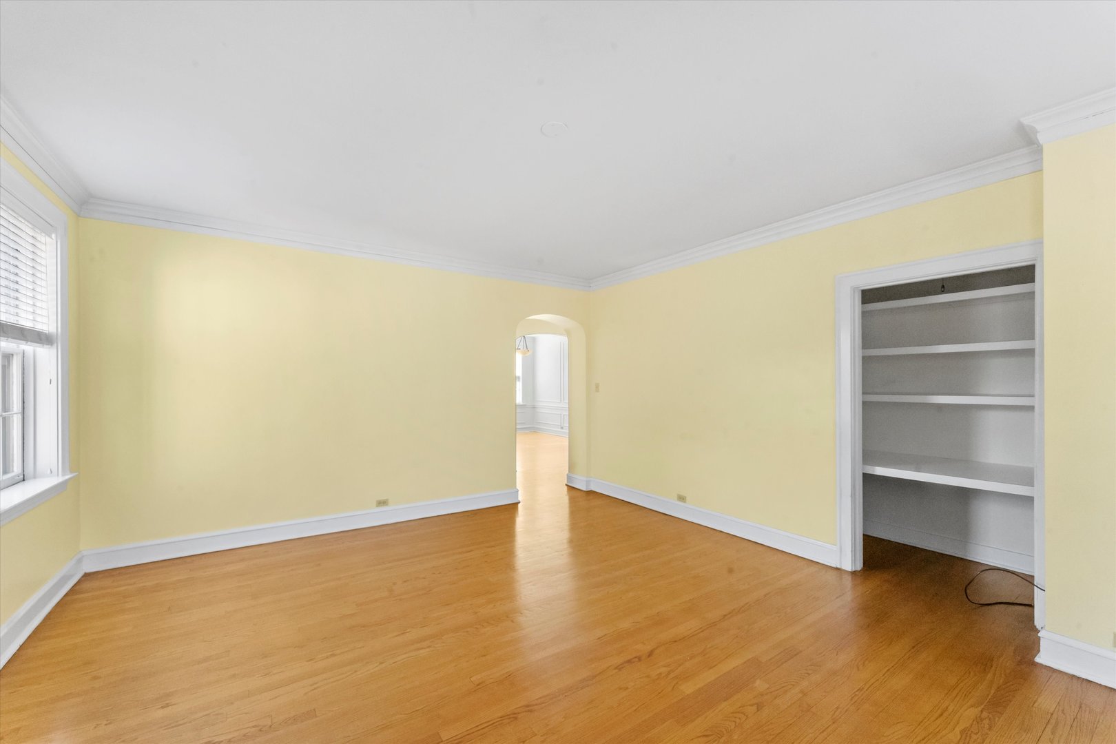 1316 Maple Avenue, Unit E3 Evanston, IL 60201 - Photo 5 of 22 a view of an empty room with a window and wooden floor