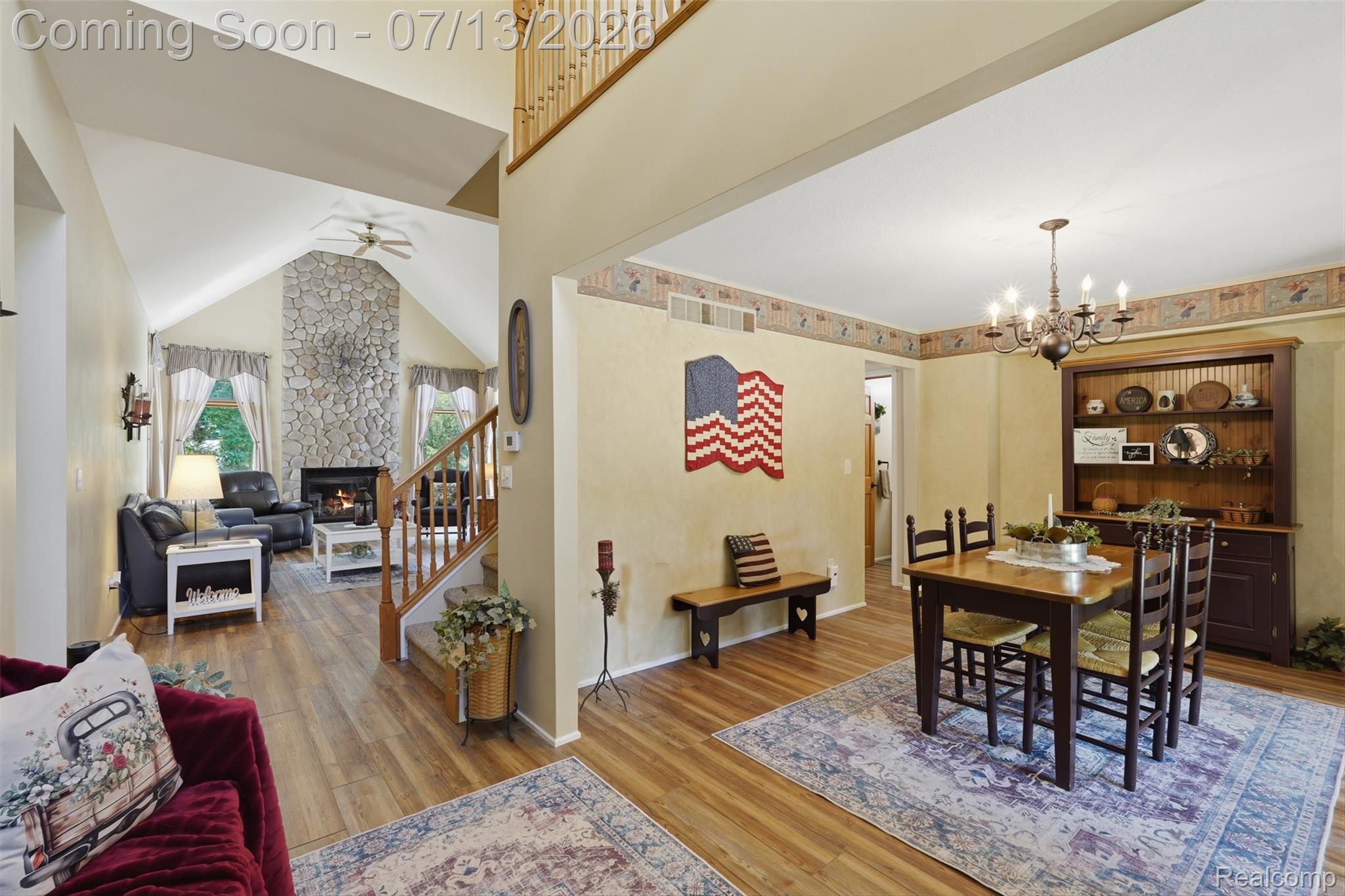 10525 Antcliff Road Brooklyn, MI 49230 - Photo 5 of 80 Vaulted ceiling living area featuring a stone fireplace and new laminate flooring