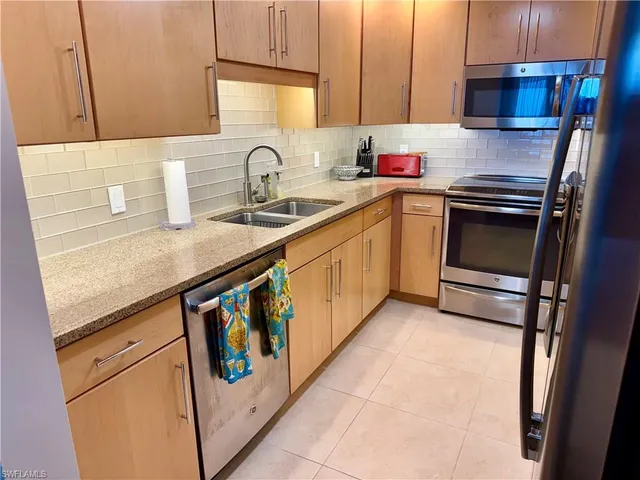 a kitchen that has a sink and a stove