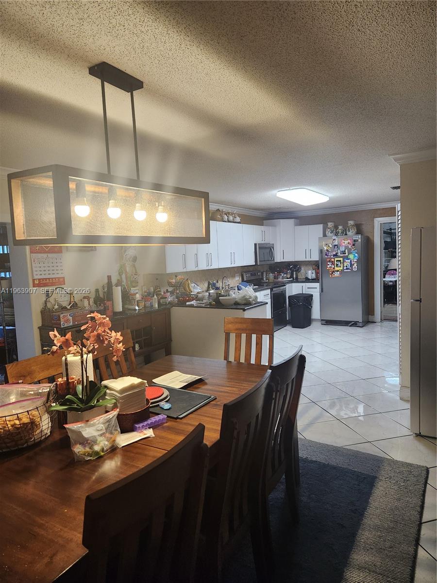23801 Southwest 217th Avenue Homestead, FL 33031 - Photo 11 of 14 a kitchen with stainless steel appliances kitchen island granite countertop a sink and cabinets