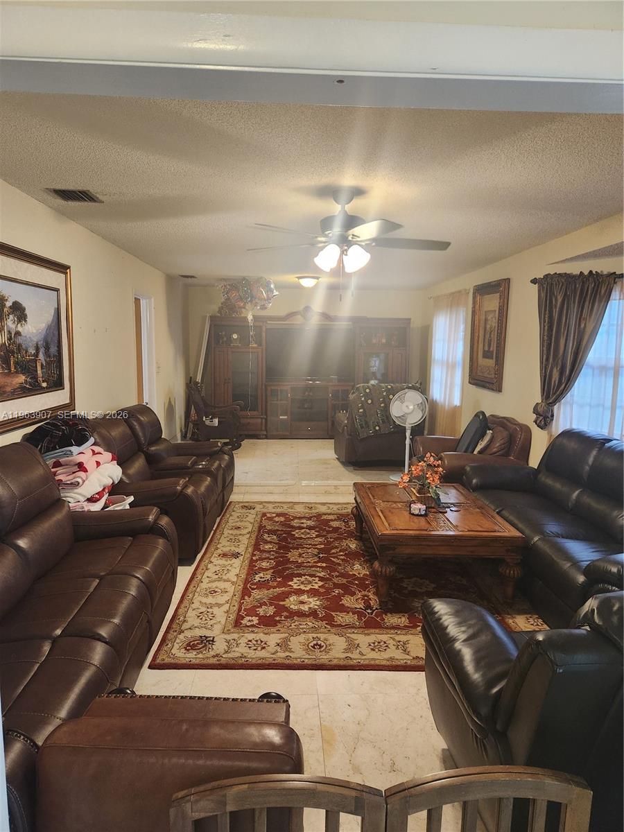 23801 Southwest 217th Avenue Homestead, FL 33031 - Photo 10 of 14 a bed sitting in a room next to a lamp