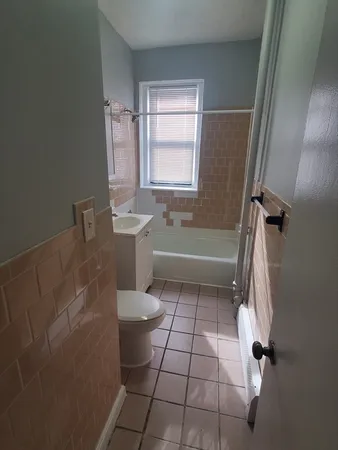 a bathroom with a shower a toilet and sink