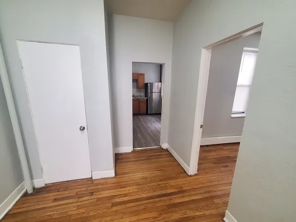 a view of a hallway with wooden floor