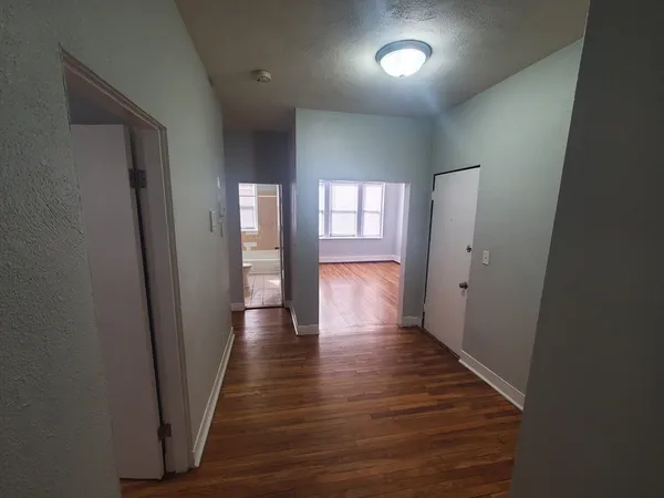 a view of hallway with wooden floor