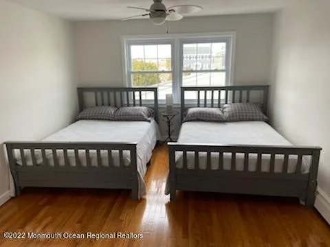 a bedroom with two beds and a window