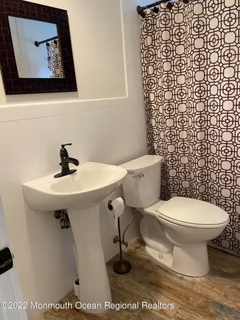 a bathroom with a sink toilet and a mirror