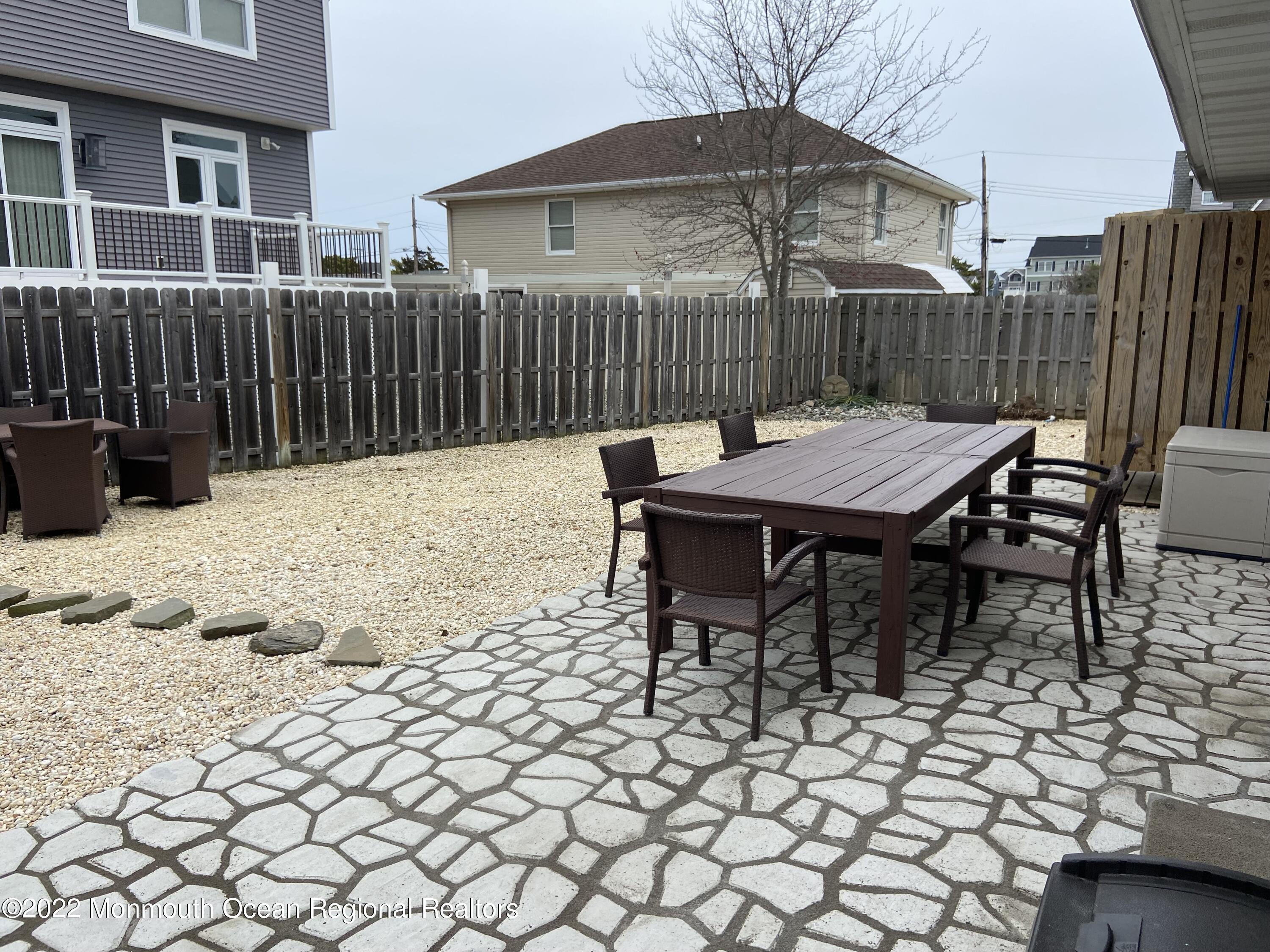 452 Marathon Court Lavallette, NJ 08735 - Photo 8 of 20 a view of a chairs and table in backyard