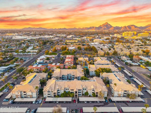 an aerial view of residential houses with city view