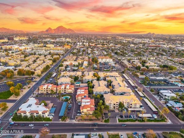 an aerial view of residential houses with city view